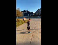 Young boy spin ball on finger driveway