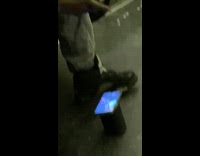 Guy plays video game with controller on train 