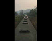 Guy stands on top of moving train outdoors 