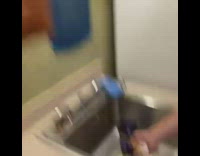 Man crushes egg in the palm of his hand at the sink