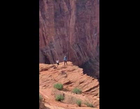 Couple stand cliff grand canyon tripod selfie