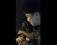 Two guys in car eating fast food on date 