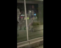 Pet dog barks on the glass with the picture of Ronaldo and Neymar