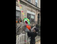 Guy makes chute so he can pass out candy from third floor 