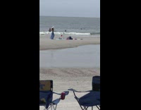 Woman hat blue dress sit pose beach
