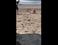 Man silver bikini stockings on his head beach