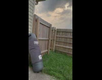Man kick bag accidentally hit wooden fence