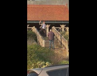 Mr. Bean Impersonator dances at the stairs