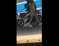 Guy with red white motorcycle on train platform 