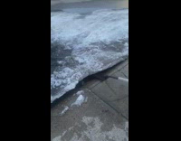 Dirty water under the chunk of ice