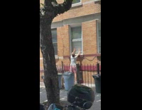 Guy climbs into apartment window head first from outside