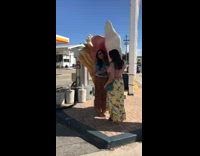 Two girls pose with giant seashell 