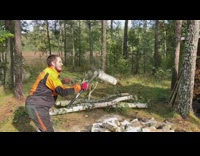 Guy chops wood mid air axe trees