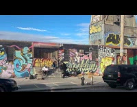 Men filming music video on sidewalk part 2