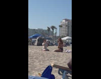 Girl black bikini kneel beach remove glasses