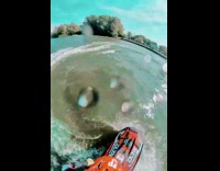 Guy rides and jumps red jet ski 