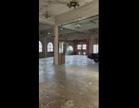 Man with a Deadpool mask poses at a vintage house
