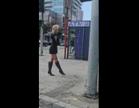 Collab IITW - Woman black dress poses on the sidewalk