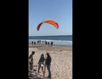 Orange Parachute Guy Tries to Run Across Beach