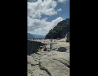 Two girls grey rock ocean view mountain