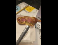 Boy eats corndog sideways on stick