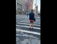 Guy tied behind back walks on street