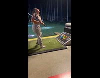 Drunk woman plays golf at practice range 
