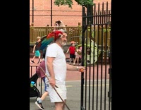Man with parrot on shoulders enter playground