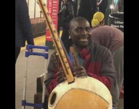 Man plays with traditional string instrument 