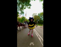 Collab WINY - Woman inflatable bee costume skates at street