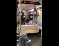 Guy on couch films video inside train