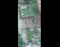 man records dance routine in front on building 