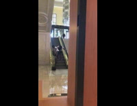 two women twerk coming down escalator 