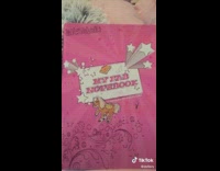 Girl reads 10 year old diary entry pink notebook