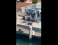 Woman handcuffed walks at pier for video