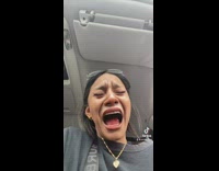 Two women in car laughing at snapchat filter