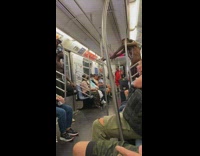 Two men performs in the middle of the train wagon