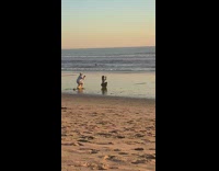 Woman crouch hand hold sunset beach pictorial