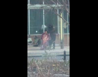 Man getting a haircut at bus stop