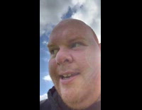 Man Finds Pig Toy on Grass Field