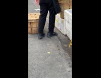 Woman pick up crabs with tong on street