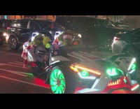 The Grinch dances in neon lights sports car on the street