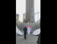 Guy white dress pink disc behind head 