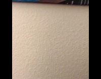 Cat playing peekaboo on top of mattress gets closer