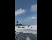 People on road moved by  beach wave