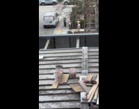 Woman bikini top poses on the sidewalk