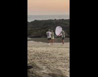 Girl baggy shirt sing light reflector beach