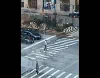 Guy doing somersaults while crossing crosswalk