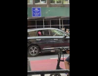 Spiderman sticks head out of car 