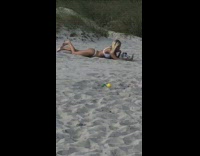 Girl takes selfie on beach sand 